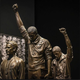 A sculpture at the new National Museum of African American History and Culture portrays the 1968 Olympic podium protest by Tommie Smith (center) and John Carlos (right)